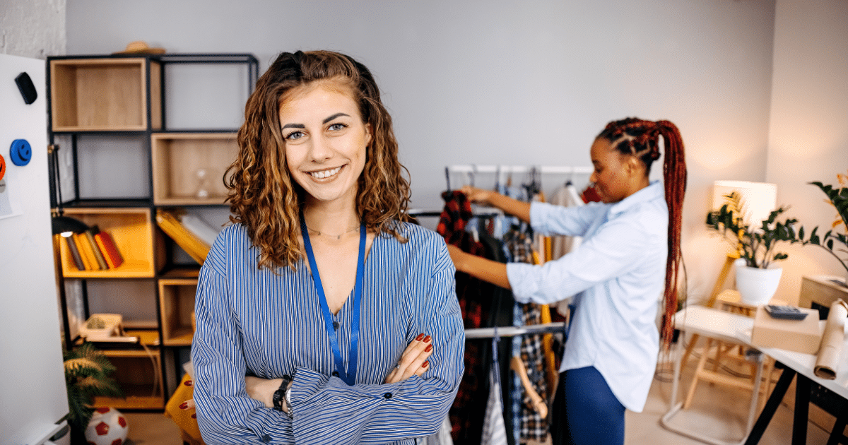 Smiling businesswoman in a clothing store, showcasing affordable financing options for veterinary care loans.