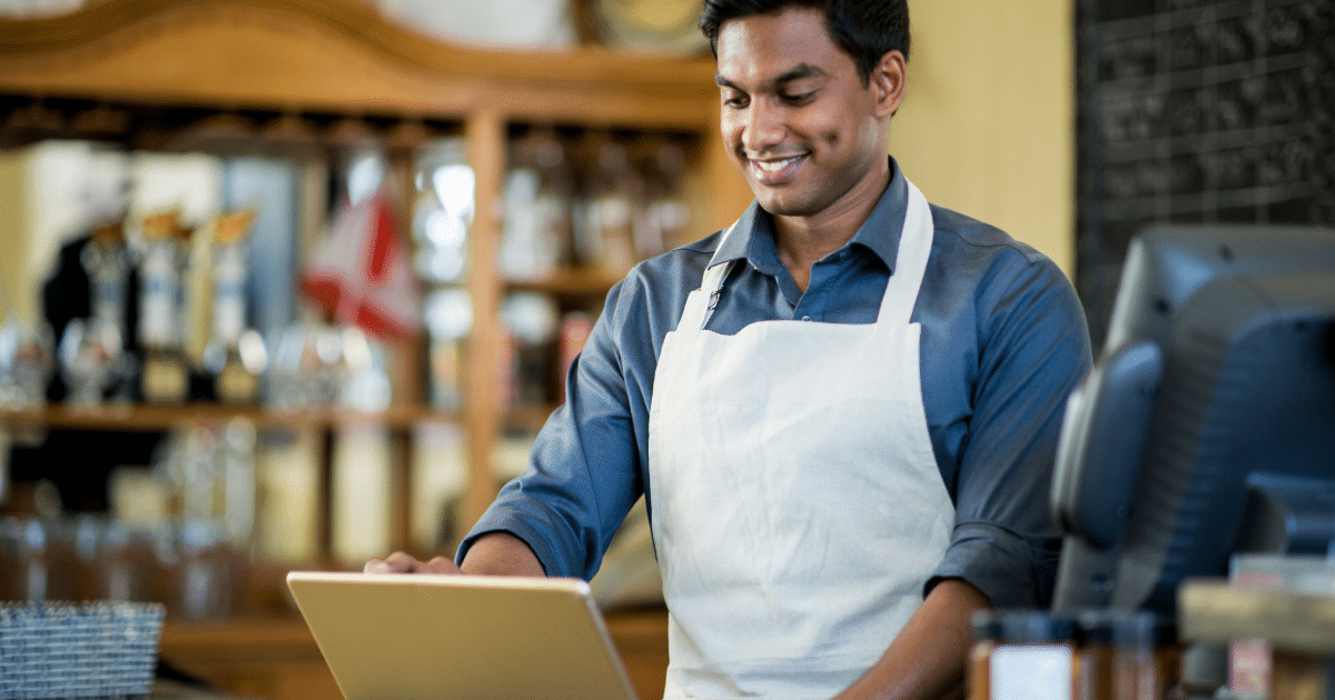 Business owner managing finances with an unsecured line of credit for growth and stability in a hardware store.