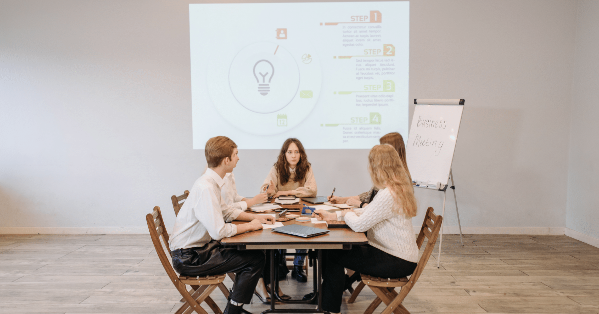 Business meeting discussing effective marketing strategies with a presentation on growth steps and ROI analysis.