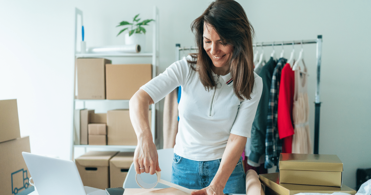 Woman packaging products in a small manufacturing business, highlighting the benefits of manufacturing and funding solutions.