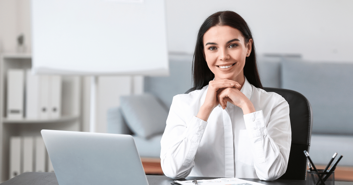 Smiling businesswoman at desk promoting unsecured credit lines for small businesses and financial growth solutions.