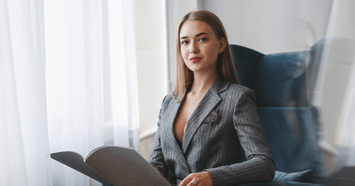 Professional woman in a business suit engaging with corporate materials, symbolizing effective corporate website enhancement.