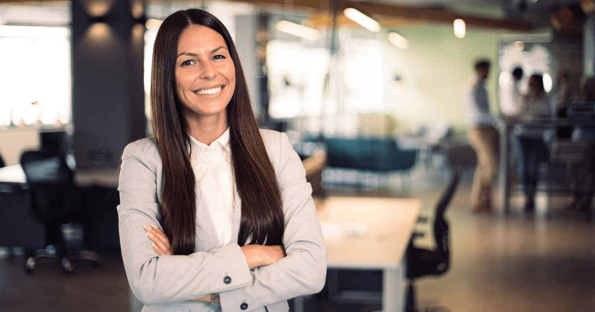 Professional woman smiling in a modern office, representing branding and business growth with Advance Funds Network.