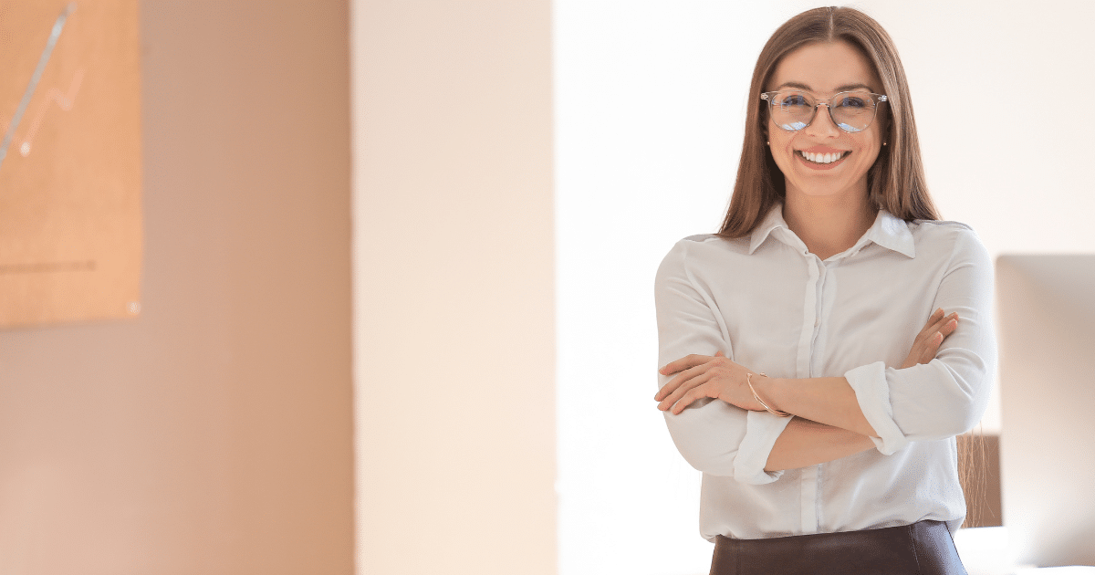 Smiling businesswoman in a professional setting, representing small business empowerment and web solutions.