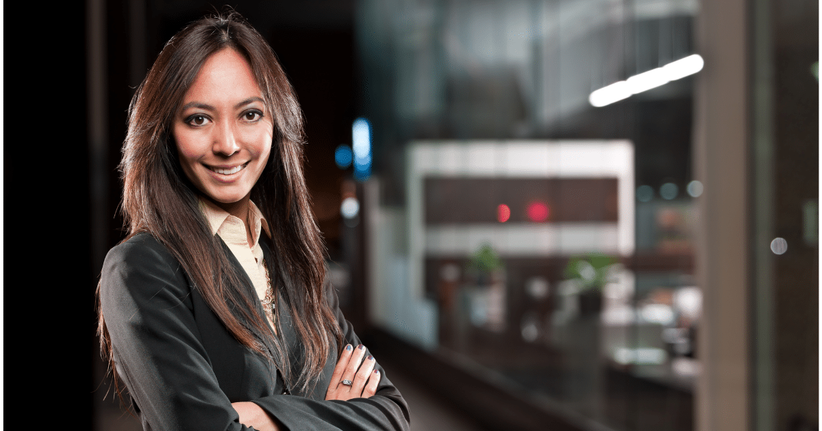 Professional woman smiling confidently in a business setting, representing small business growth and financing options.
