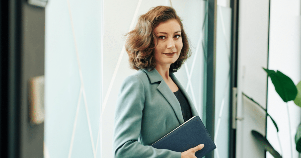 Professional woman holding a notebook, representing strategies for boosting sales and engaging impulse buyers.