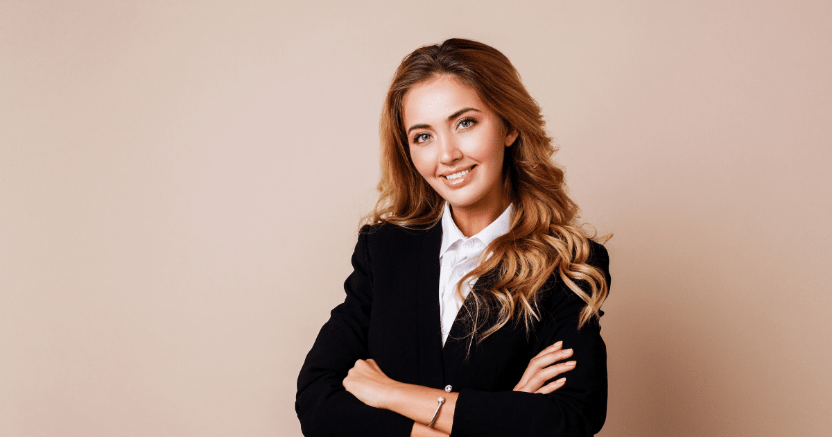 Professional woman smiling in a business suit, representing eCommerce payment gateway solutions for online stores.
