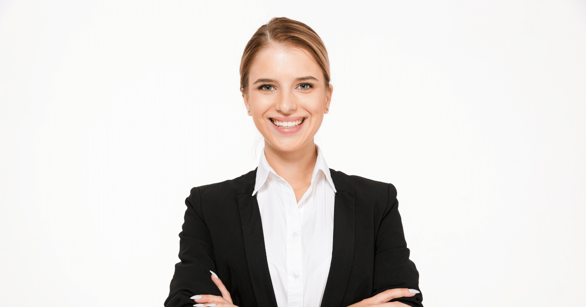 Smiling businesswoman in a suit, representing success strategies for small business growth and customer relationships.