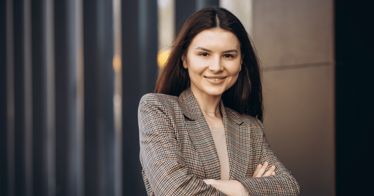 Professional woman smiling in a blazer, representing the restaurant industry's seasonal changes and business strategies.