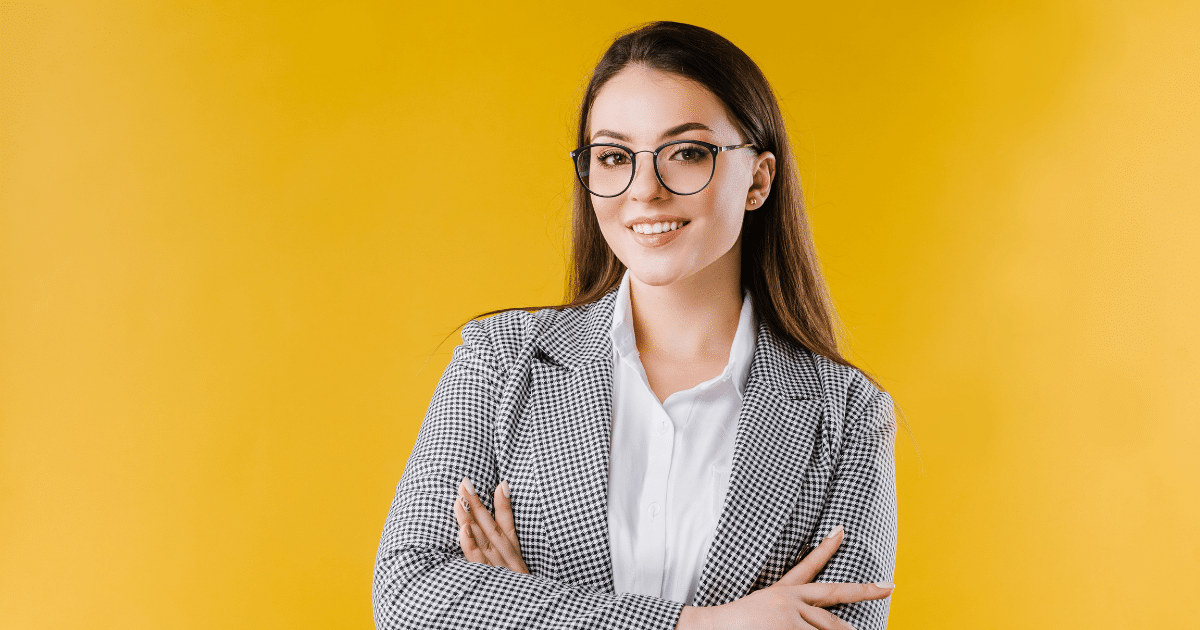 Professional woman in glasses smiling, representing small business marketing strategies and Facebook news feed updates.