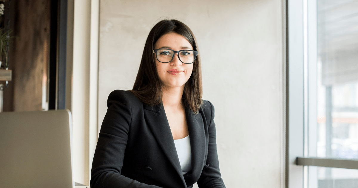 Professional woman in a business suit, representing cost-effective marketing strategies for small businesses.