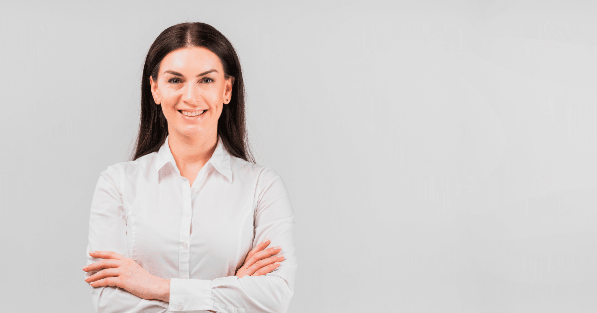 Professional woman smiling, representing customer loyalty strategies and business success in a modern setting.