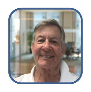 Smiling man in a professional setting, representing business financing options like SBA loans and cash advances.