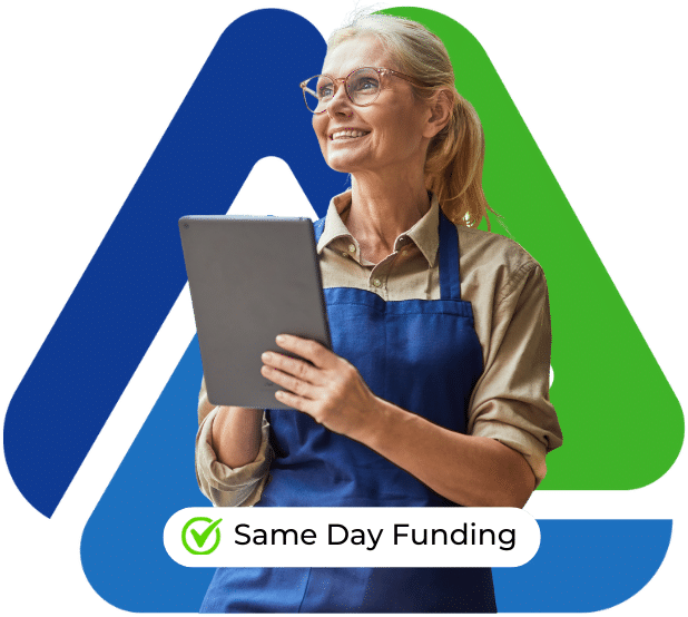 Smiling businesswoman in apron holding a tablet, promoting same day funding for working capital loans.