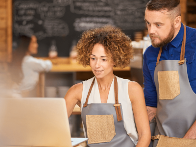 Business owners discussing unsecured credit options for rebuilding after Hurricane Sandy in a cafe setting.