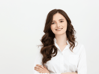 Professional woman smiling in a white shirt, representing business growth and effective press release strategies.