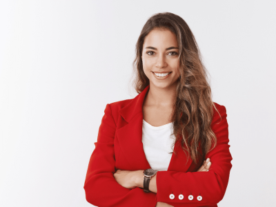 Smiling businesswoman in a red blazer promoting employee motivation and workplace positivity strategies.