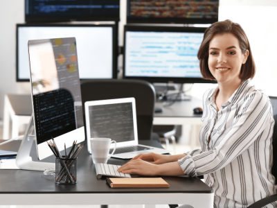 Business owner at a desk with computers, emphasizing corporate liability and asset protection strategies.