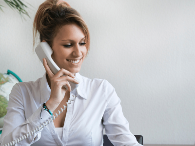 Businesswoman on the phone discussing private equity risks for small business funding and growth opportunities.