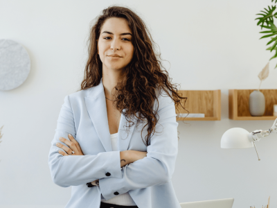 Business professional in a light blazer, promoting Yelp reviews to maximize business revenue and customer engagement.