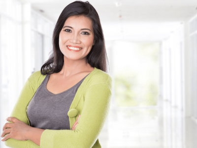 Smiling businesswoman in a bright office, representing holiday season website optimization and customer engagement strategies.