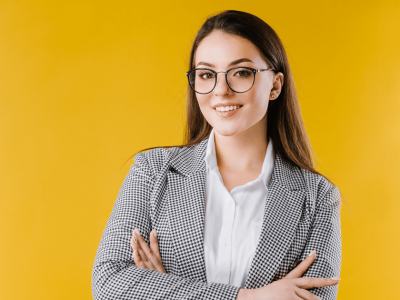 Professional woman in glasses smiling, representing small business marketing strategies and Facebook news feed updates.