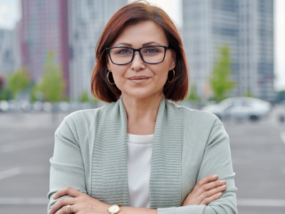 Confident businesswoman in urban setting, representing expert tips for business loan approval and financial growth.