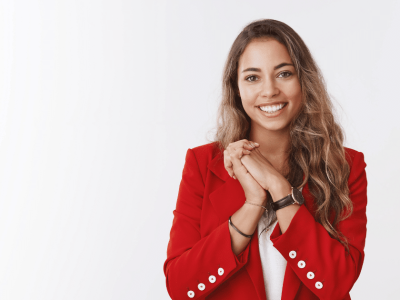 Smiling woman in a red blazer representing effective customer engagement strategies for small businesses.