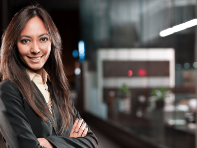 Professional woman smiling confidently in a business setting, representing small business growth and financing options.