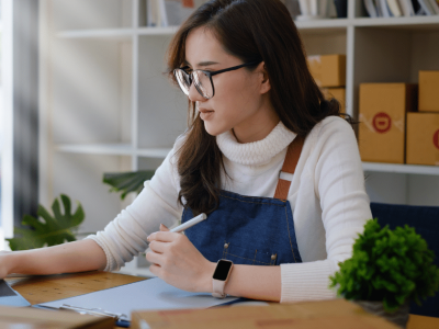 Business owner managing finances with accounts receivable financing for improved cash flow and efficiency.