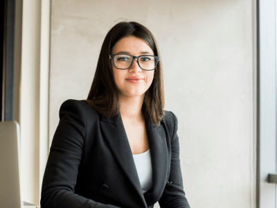 Professional woman in a business suit, representing cost-effective marketing strategies for small businesses.