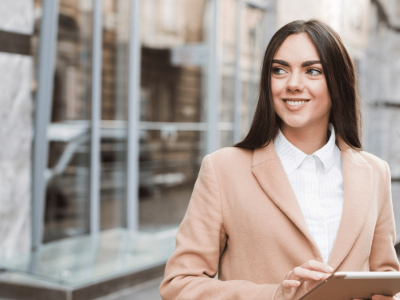 Businesswoman using technology for growth and success in a modern urban setting.
