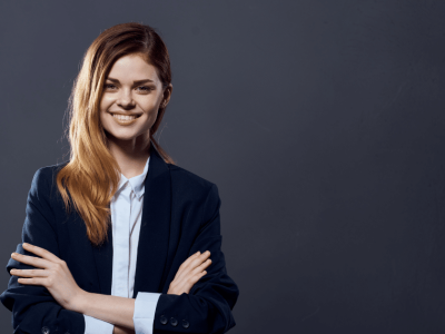 Smiling businesswoman in a suit, representing financial success and avoiding common pitfalls in business management.