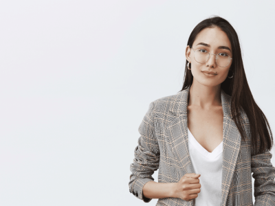 Professional woman in a blazer, representing key business practices for small business owners and effective communication skills.