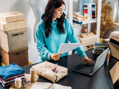 Woman managing online business with laptop, showcasing internet marketing trends and e-commerce strategies.