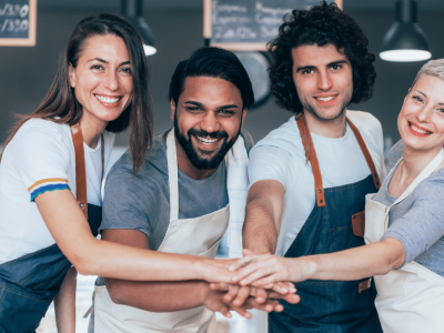 Diverse small business team collaborating and supporting each other to improve business strategies and growth.