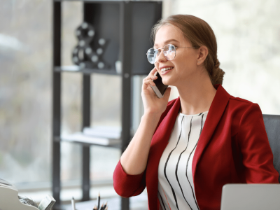 Professional woman on the phone in a modern office, representing business growth and customer service excellence.